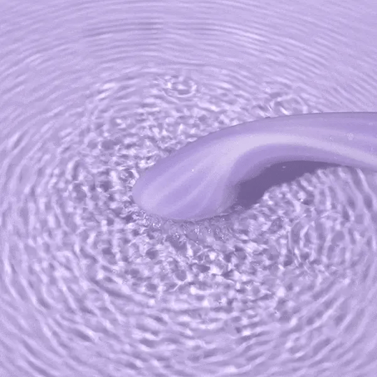 Close-up of a roll of purple toilet paper with water droplets on the surface.